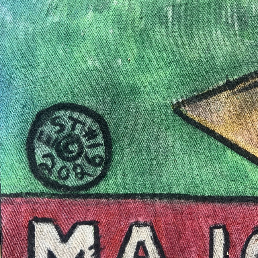 Macro detail of the hand-lettered Major League nameplate