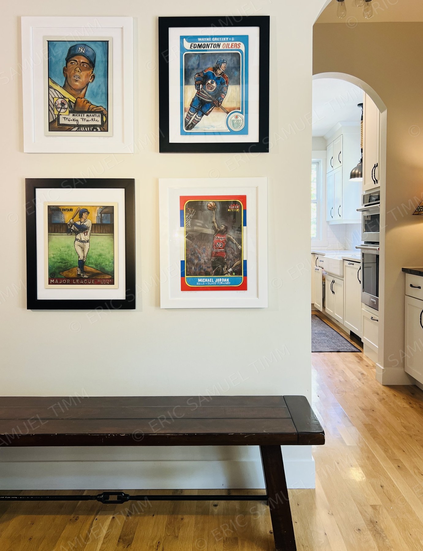 Four framed prints — Mickey Mantle, Wayne Gretzky, Shohei Ohtani, and Michael Jordan — hung together on a wall in a client's home